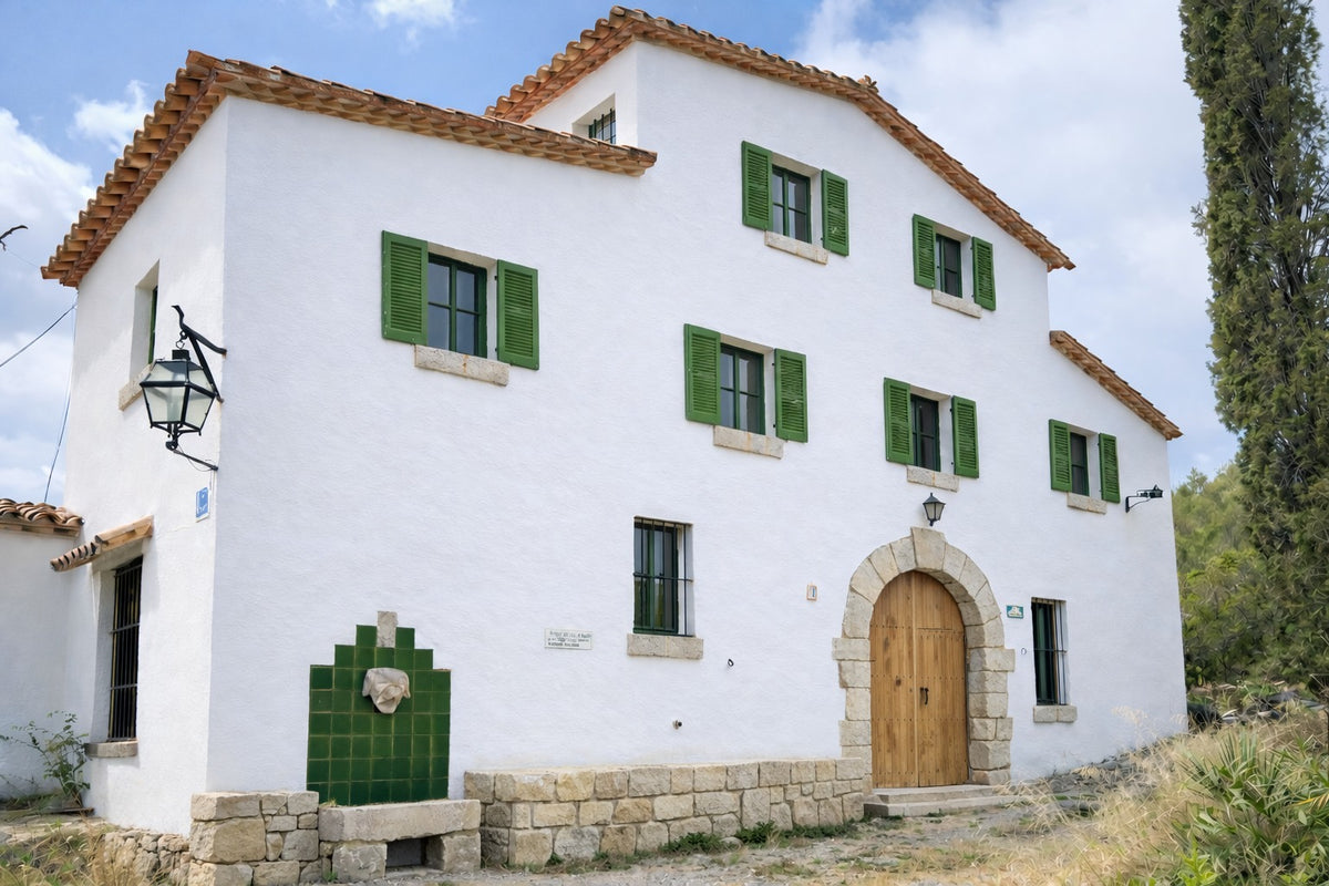 The whitewashed facade of the masia
