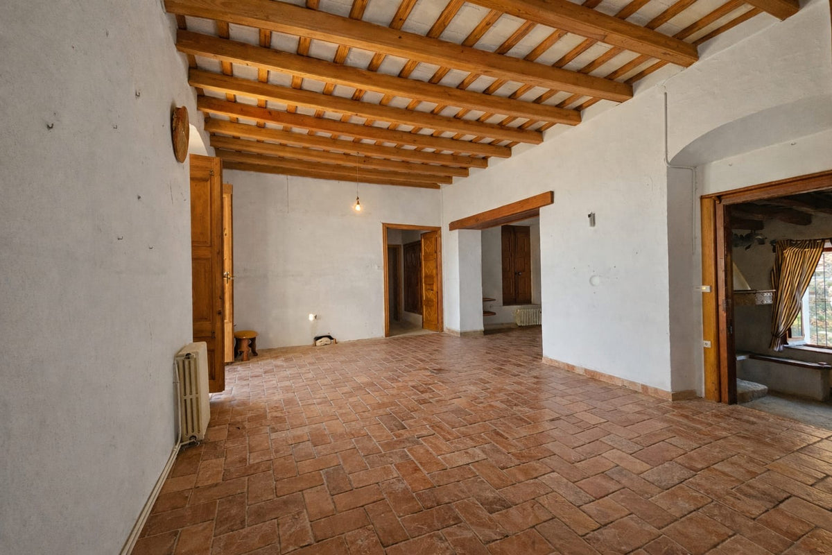 An empty room with its original tiled floor